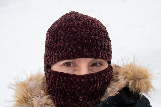 woman on a cold day in a balaclava. New hat style. Fashionable mask on a beautiful woman, good protection from the cold