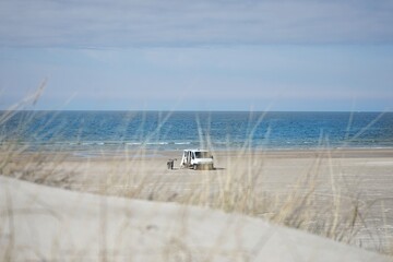 Campervan and motorcycle on the beach