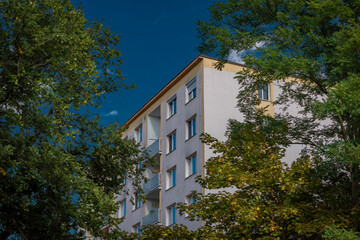 Fototapeta na wymiar Block of flats with blue sky and sunny autumn clear day in Rakovnik town