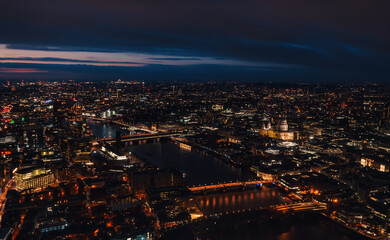 Fototapeta na wymiar Aerial view of north east part of London, in evening. St Pauls Cathedral visible over river Thames
