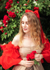 blonde in the garden of red roses