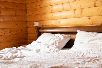 Double bed in a bedroom in a wooden house, apartment and interior, bed