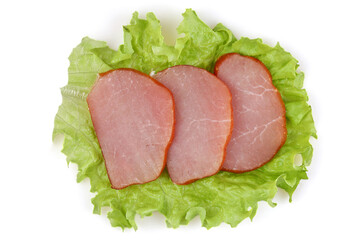 Pieces of raw smoked balyk on a leaf of fresh lettuce.