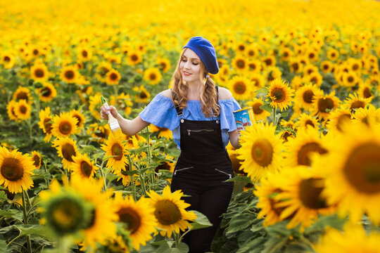 a girl in the image of an artist draws a field of sunflowers