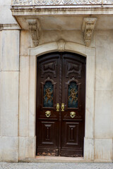 Aged vintage door in baroque architectural style outside on the street of Elvas, Alentejo region, Portugal