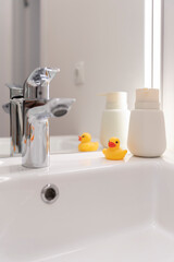 Yellow duckling in the bath. Plumbing, faucet and sink