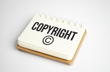 word Copyright text on white paper on light background