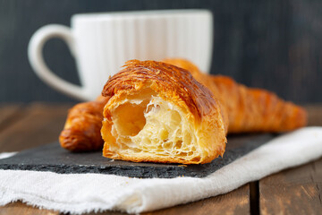 croissant on dark wooden surface and empty space for your text