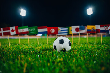Football tournament. International games. Sport photo. Football ball and nationals flag including flag of Qatar, Brazil, Germany, France and others football Countries