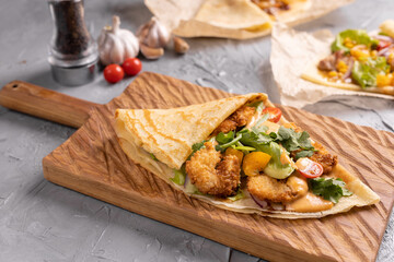 Pancake or crepe with fried shrimp tomatoes and vegetables and cheese