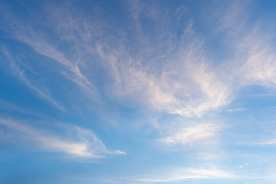 Photo of some white magenta clouds and blue sky cloudscape