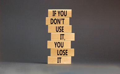 Use or lose symbol. Concept words If you do not use it you lose it on wooden blocks on a beautiful...
