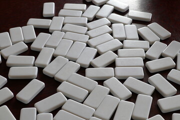 Domino or Mexican train game. Blank side up. Mix around like a puzzle. Close up. 