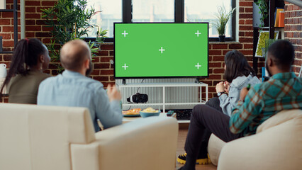 Soccer fans watching football match using greenscreen on television, enjoying sport game tournament...