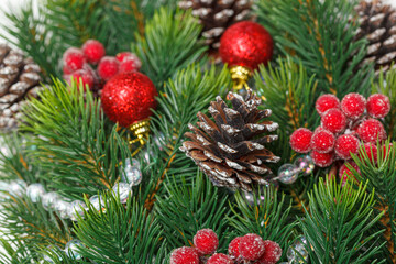 Christmas composition, Christmas tree branch with toys, cones on a wooden background