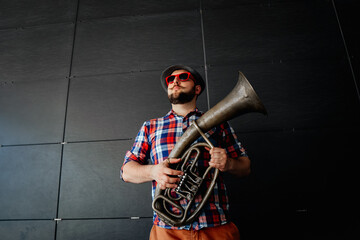 Street musician with a wind instrument and sunglasses