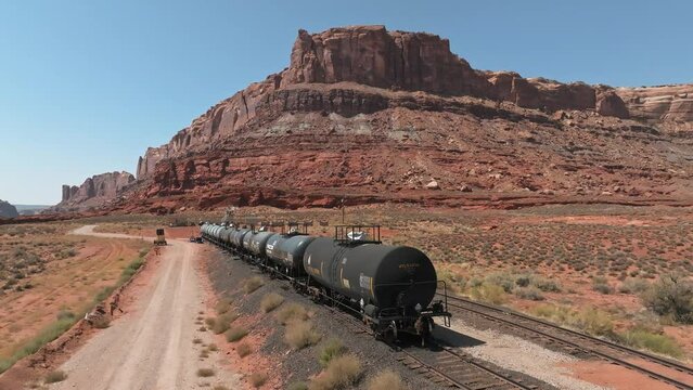 Aerial view of the cargo locomotive railroad engine crossing Arizona desert wilderness. Logistics transportation across America.