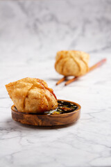 Fried Dumplings with Soy Sauce Garnish on Marble background