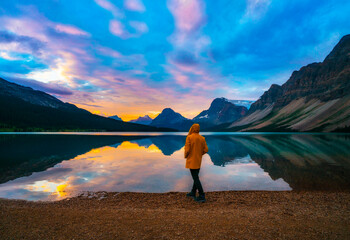 Man On Scenic Mountain Outdoor Lake Shore Getaway At Colorful Sunset Sunrise In Bow Lake Rocky...