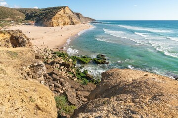 View from a high point of people in Sao Juliao beach in Sintra, Portugal