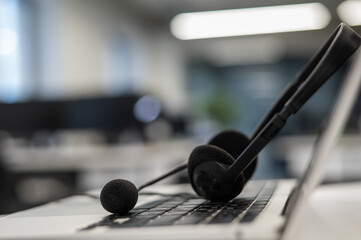 Headset on a laptop keyboard in an empty office.