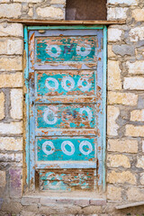 A blue painted door on a building in the village of Faiyum.