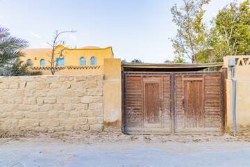 Wooden gate in a wall in the village of Faiyum.