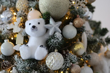 New Year's Christmas decorations on the Christmas tree in white and gold colors with a polar bear