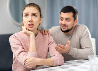 Obraz premium Stressed frustrated young adult woman feeling irritated after argue with man and ignoring him