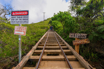 Bypass sign along the rail track of the Koko Crater Railway Trail in the suburbs of Honolulu on...