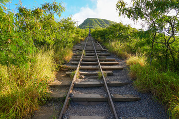 Rail track climbing uphill on the steep slopes of a volcano on Koko Crater Railway Trail in the...