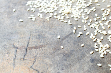 White sesame seeds in wooden bowl on vintage backgrounds