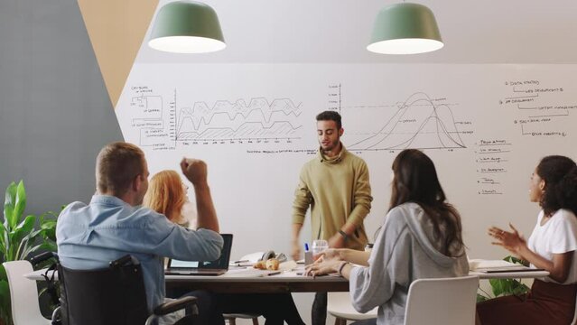 Business people high five, team manager dance and data analytics with graph analysis on whiteboard for company profit. Marketing statistics mentor, leader or professor celebrate with gen z students