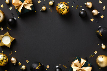 Christmas frame with gold and black balls, decorations, gift boxes, confetti. Luxury Christmas greeting card template, New Year banner mockup. Flat lay, top view, copy space.