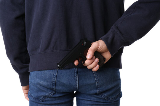 Man hiding gun behind his back on white background, closeup