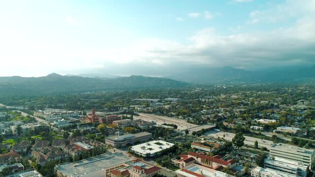 Scenic drone aerial shot of Los Angeles rolling hills of Southern California surrounded by homes and mountains. Daylight, summer. USA. High quality 4k footage
