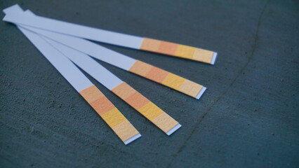 litmus paper isolated on black background - universal indicator paper with acidic testing