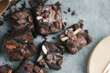 Brownies chocolate topping with chocolate chip and almond. Cut pieces to fit. Top view
