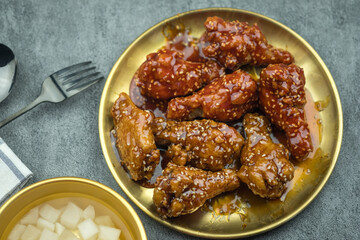 Delicious home style Korean fried chicken with spicy sauce and sweet sauce on golden dish