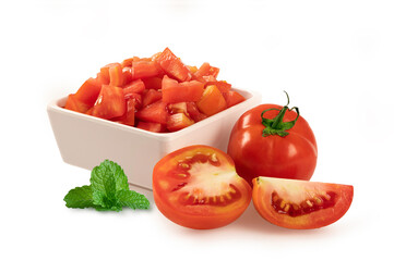 Diced tomato in bowl with fresh tomato and mint on white