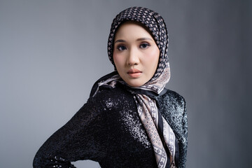 Portrait of a beautiful female model wearing hijab, a lifestyle apparel for Muslim women isolated...