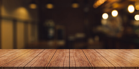 Fototapeta Empty wooden table top with lights bokeh on blur restaurant background. obraz