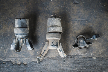 Close-up of old used car engine motor mounts.