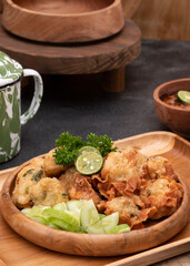 Delicious batagor or meatballs tofu is one of the popular indonesian traditional foods. Made from fish, tofu and peanut sauce. on wooden background. Top View, Close Up