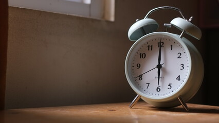 Naklejka premium alarm on wooden table and on the window sill