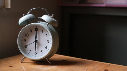 Naklejka premium alarm on wooden table and on the window sill