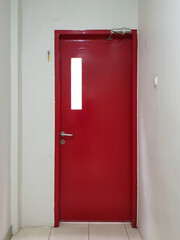 Emergency red door in a wall