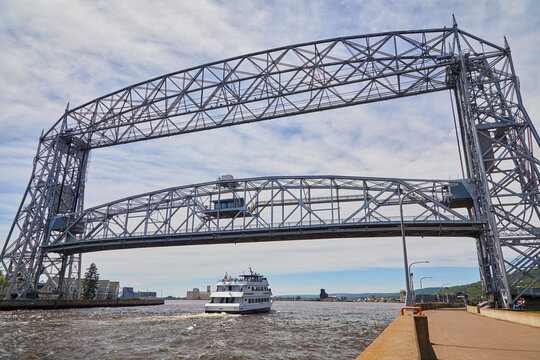 Boat passing under a historic lift bridge near Duluth Minnesota on a summer day