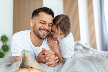 Shot of an affectionate young couple sharing a romantic moment in the bedroom at home