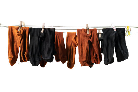 Group Of Socks Hanging On Clothes Line For Dry Under The Sunlight After Washing. Hygiene Concept ,